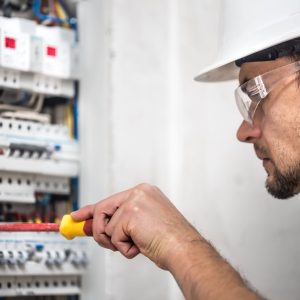 man-an-electrical-technician-working-in-switchboard-with-fuses-installation-and-connection-of-electrical-equipment-close-up-1-1 man-an-electrical-technician-working-in-switchboard-with-fuses-installation-and-connection-of-electrical-equipment-close-up-1-1